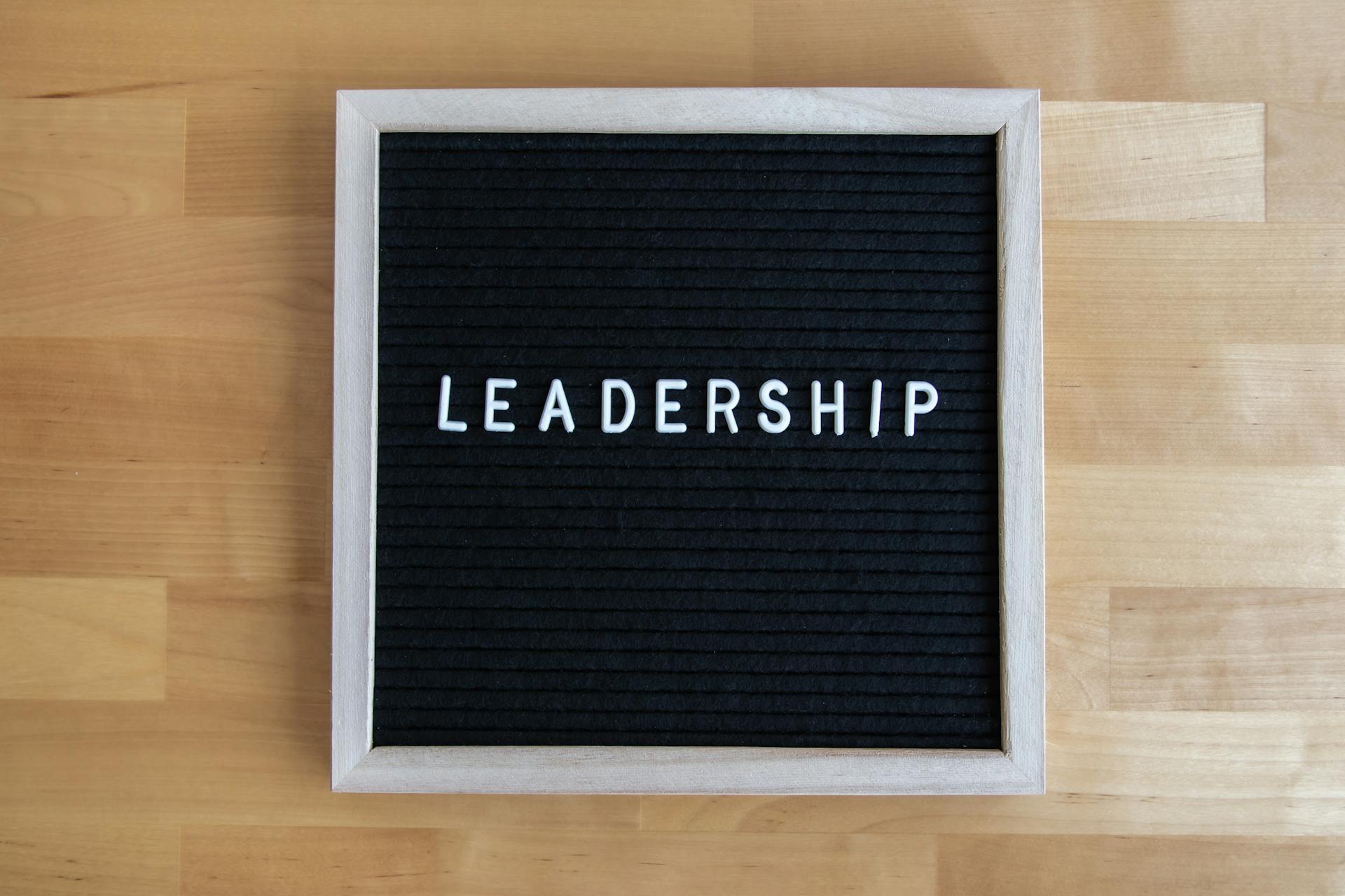 Black letter board displaying the word 'Leadership' on a wooden surface.