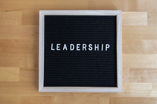 Free Black letter board displaying the word 'Leadership' on a wooden surface. Stock Photo