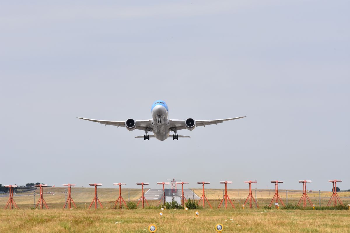 A wide-body airliner taking off from a runway