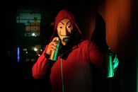 A Person Holding Spray Paint Cans