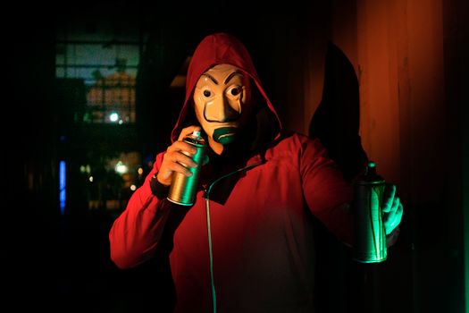 A Person Holding Spray Paint Cans