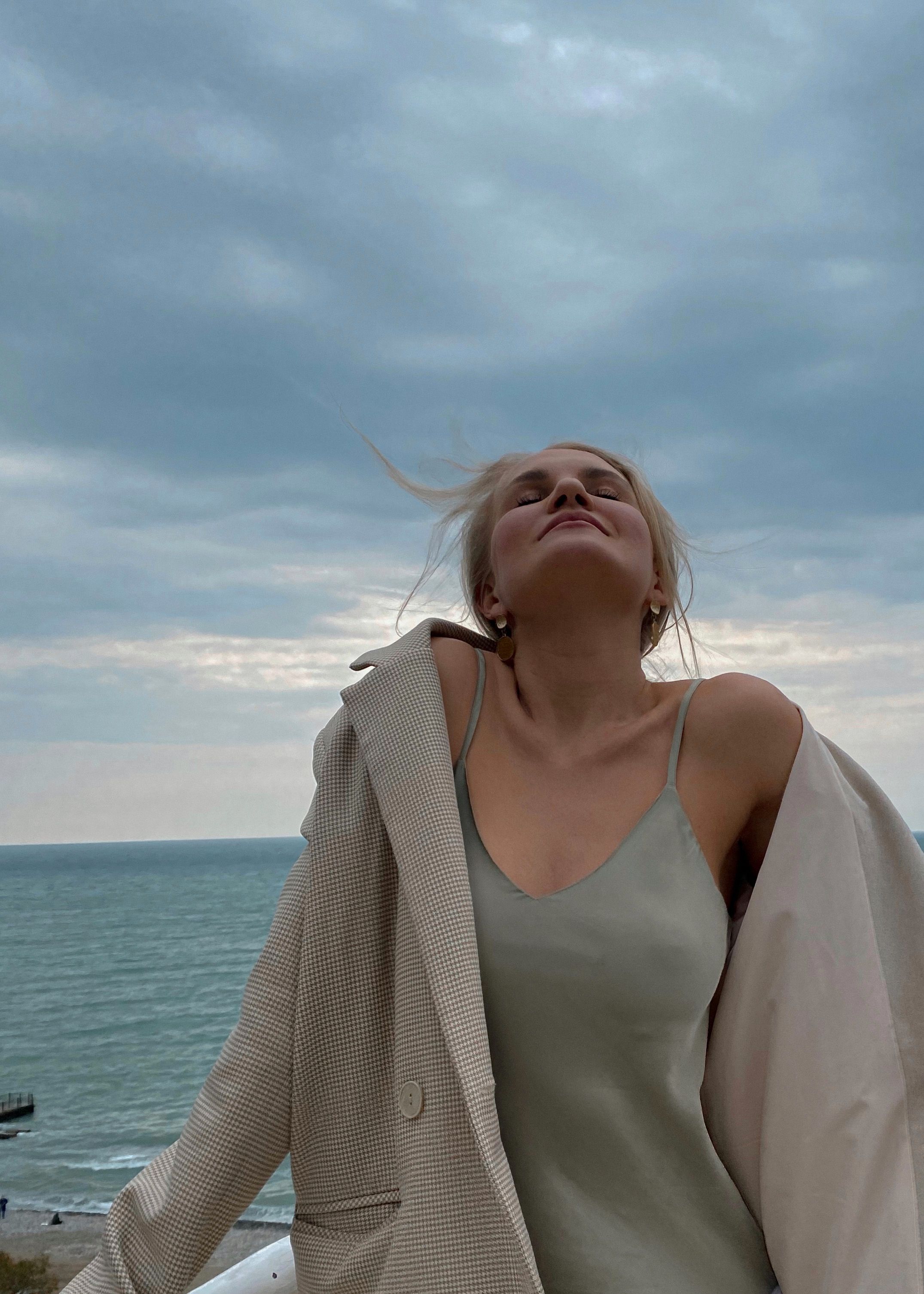 A woman enjoys the fresh sea breeze on a cloudy day in Sochi, Russia.