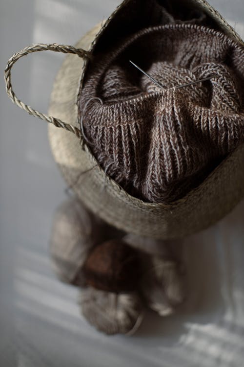 Free Knitted Garment inside a Wicker Basket Stock Photo
