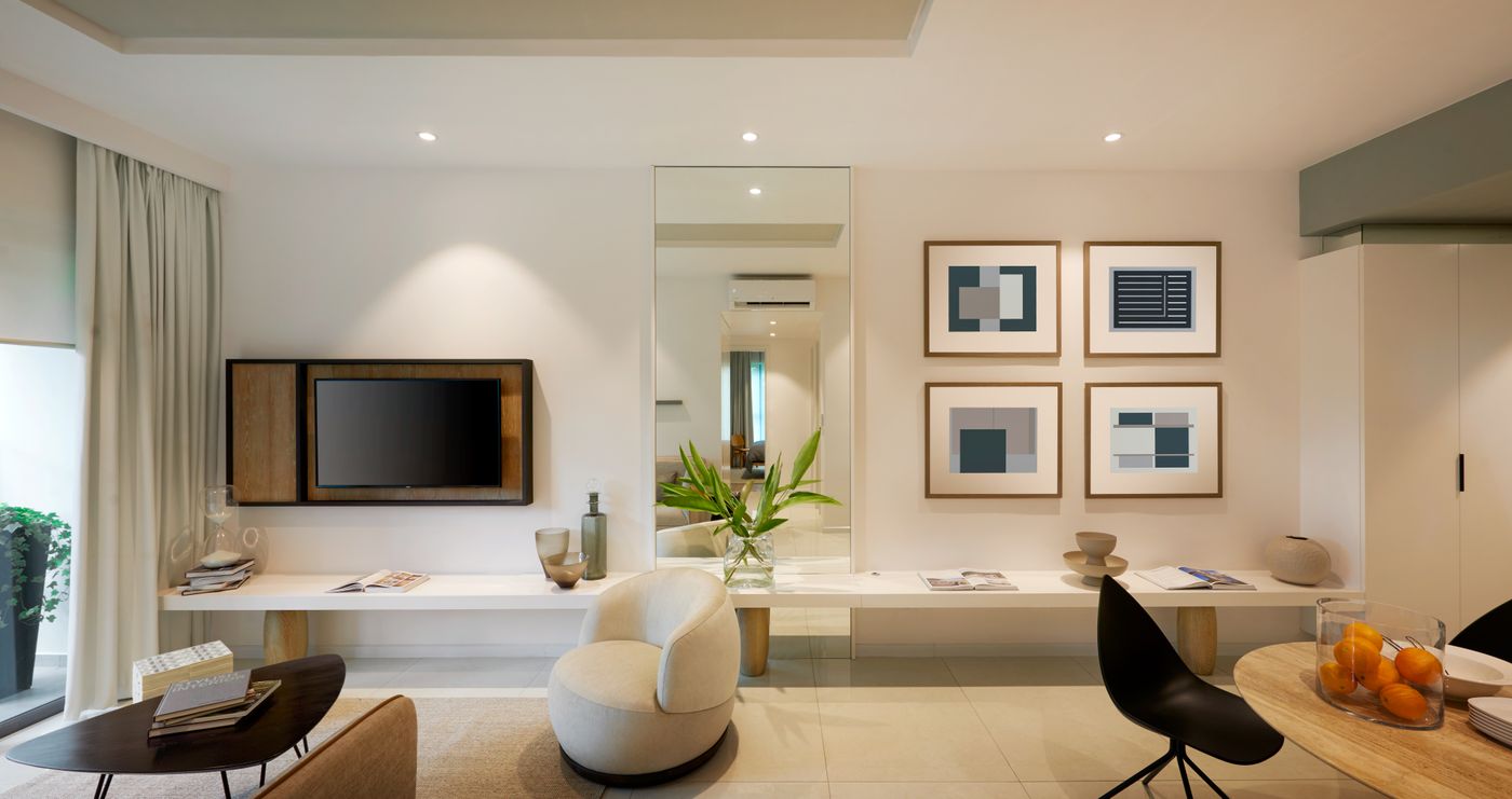 Framed prints above a low console in a bright living room — Huy Quang Nguyễn on Pexels