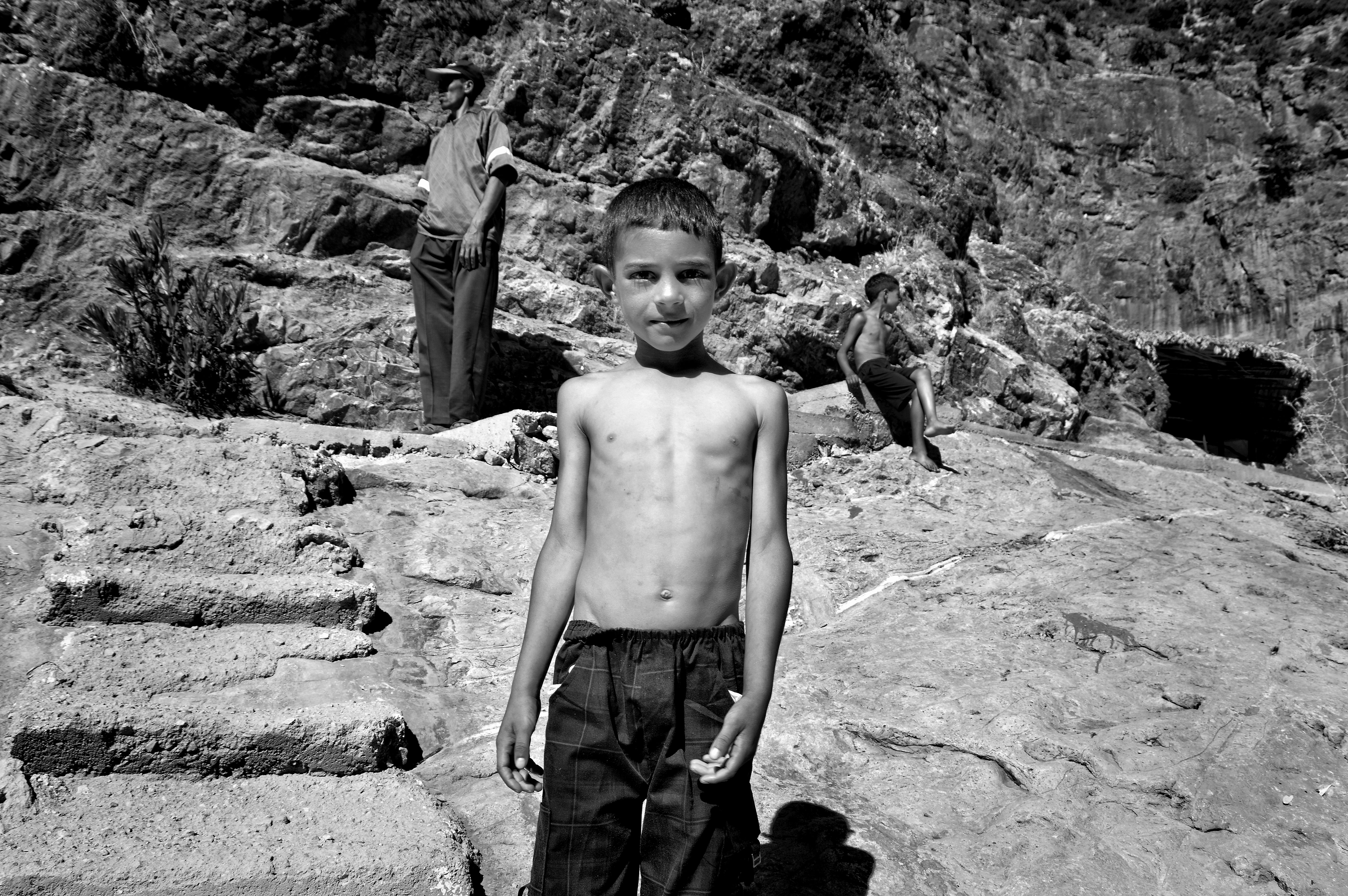 A boy standing confidently on rocks in Khenifra, Morocco. - Khenifra