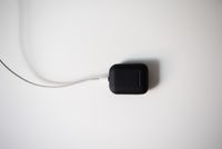 Black earbud charging case on a white background, photo by Dario Fernandez Ruz on Pexels