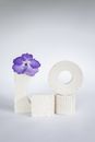 A Purple Flower on a White Stand