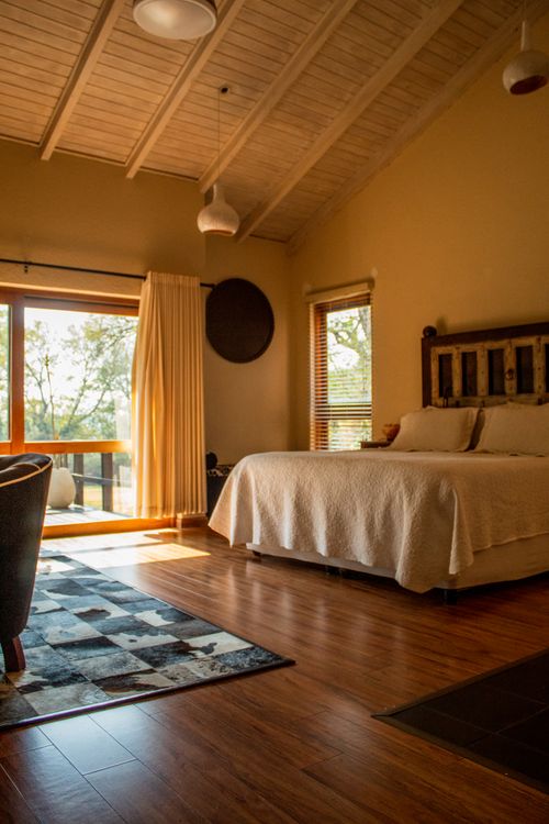 Free Inviting rustic bedroom in a cabin with natural light and cozy decor. Stock Photo