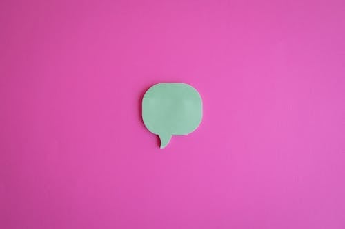 A Cutout of a Dialogue Box on a Pink Surface