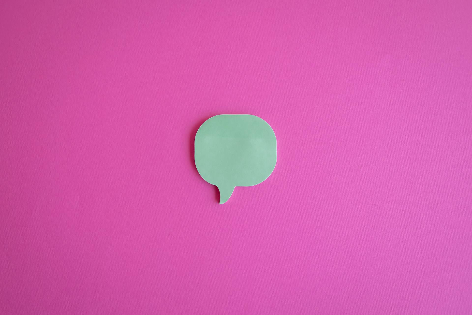 A Cutout of a Dialogue Box on a Pink Surface