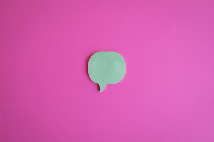 A Cutout Of A Dialogue Box On A Pink Surface