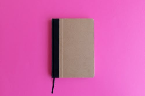 Brown Notebook on a Pink Surface