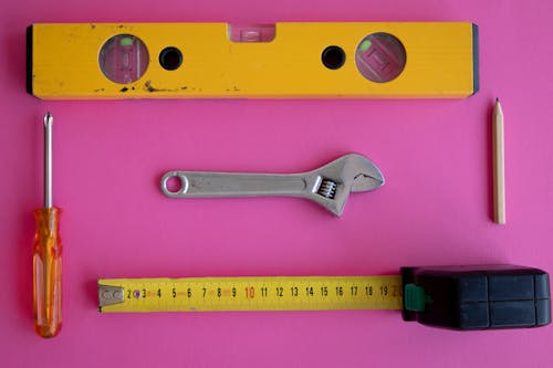 Free Carpentry Tools on a Pink Surface Stock Photo