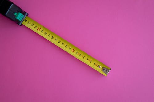 Measuring Tape on a Pink Surface