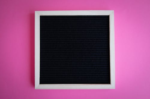 A Blank Letter Board on a Pink Surface