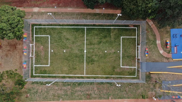 Top view of a fenced soccer field in Londrina, Brazil. Perfect symmetry and vibrant colors.