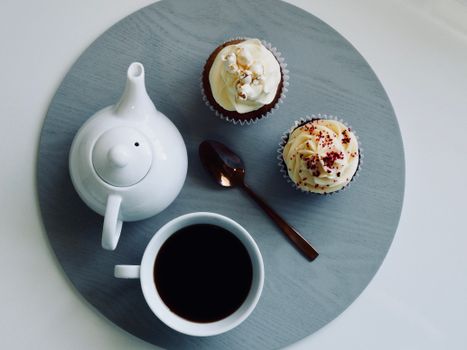 White Ceramic Cup and Teapot with Cupcakes