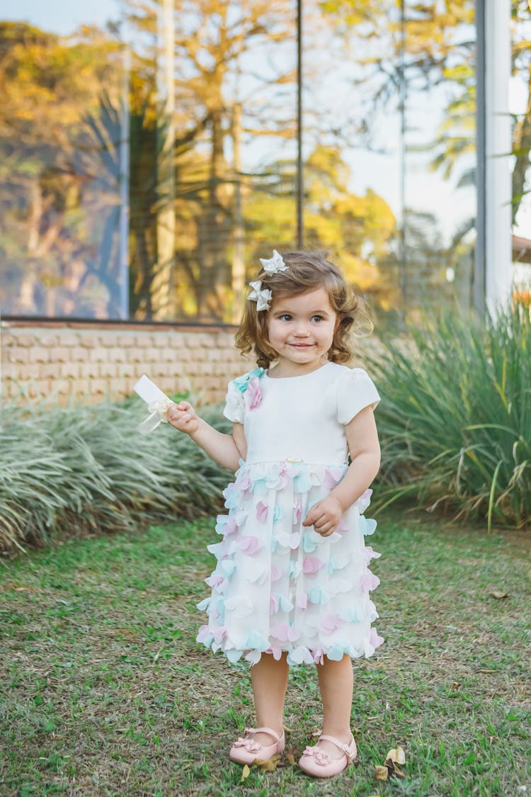 Cute Girl In Dress In Garden