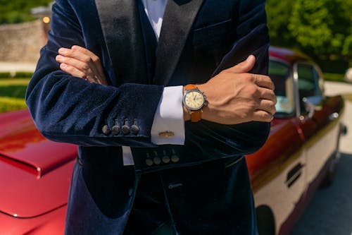 
Person in Black Suit Jacket Wearing Brown Analog Watch