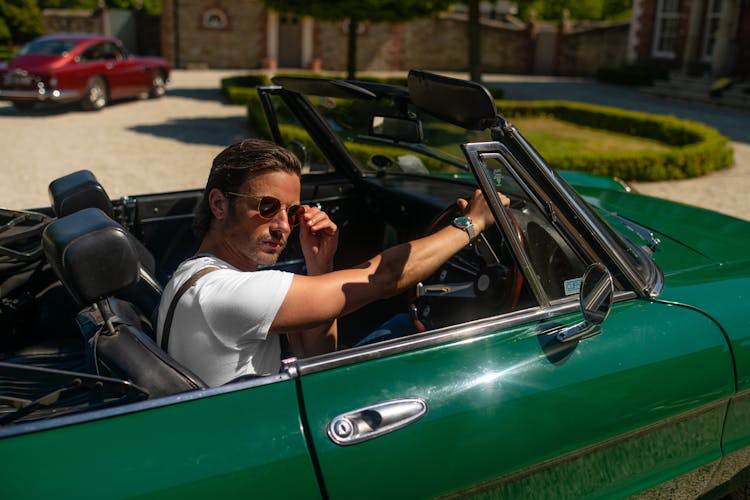 Man In White T-shirt Driving Green Convertible Car