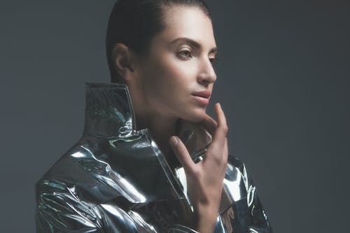 A Woman in Silver Leather Jacket Looking Afar