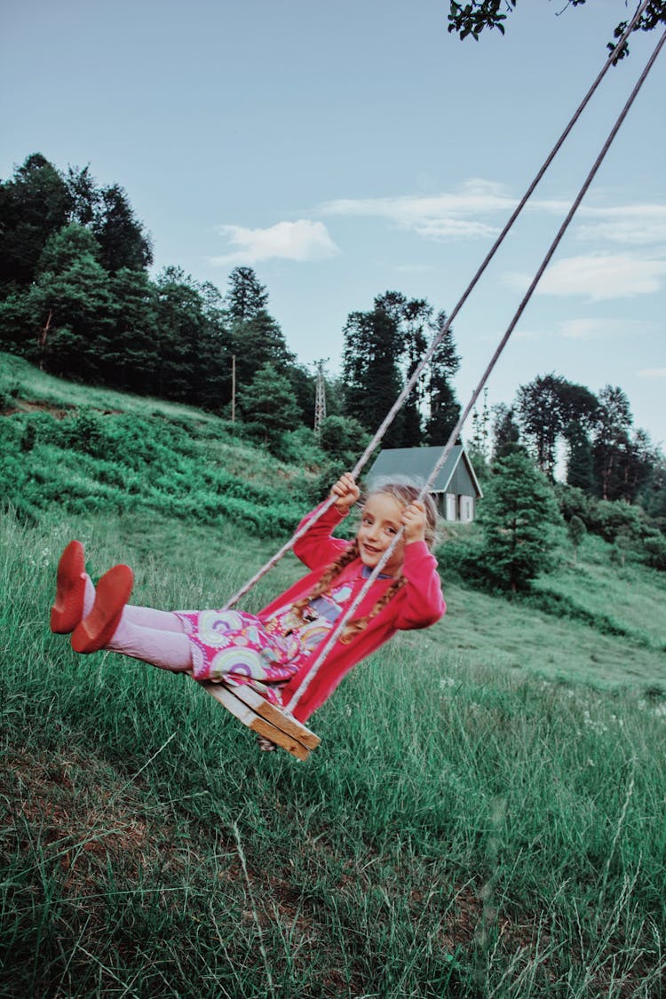 Girl Swinging On Swing