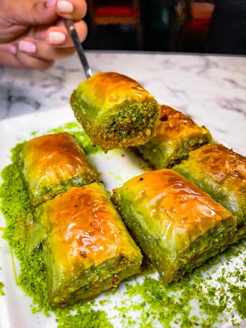 Free Close-up of delicious pistachio baklava slices on a plate, showcasing rich flavors and textures. Stock Photo