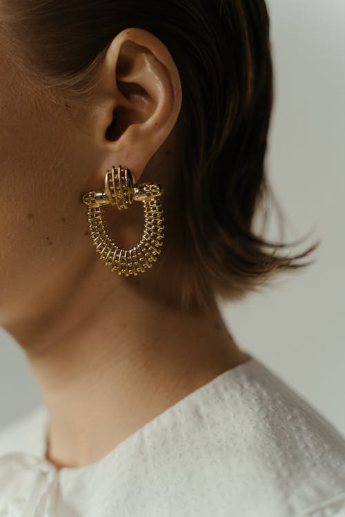 A Woman Wearing Gold Earring