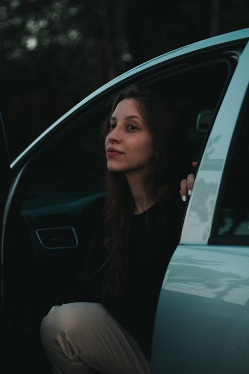 A Woman in Black Shirt Sitting Inside Car