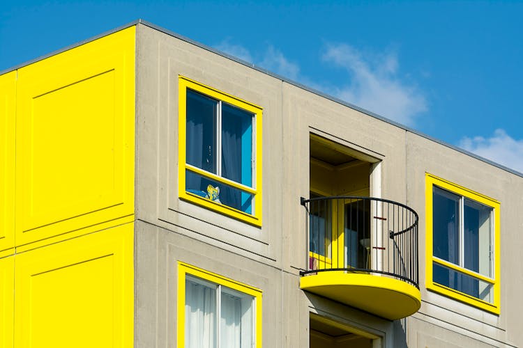 Concrete Building With Yellow Window Frames