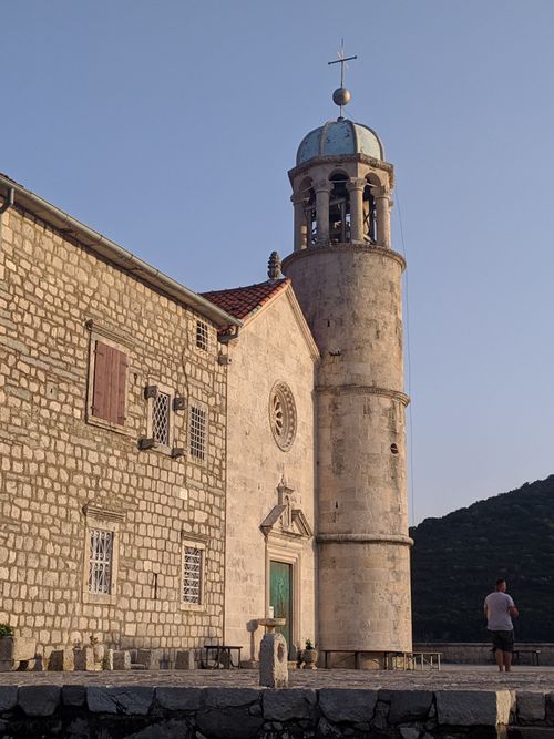 Free Historic Our Lady of the Rocks church on the islet in Perast, Montenegro under a clear sky. Stock Photo