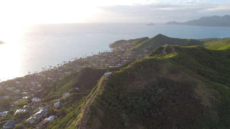 Houses On Green Mountains Near A Body Of Water