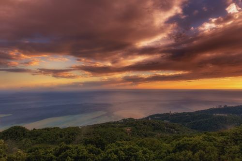 Free Marvelous sunset view over lush forests and the Black Sea coast in Sochi, Russia. Stock Photo