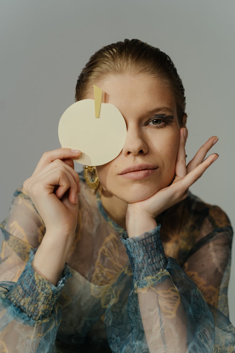 Round Paper Craft Covering The Woman's Eye