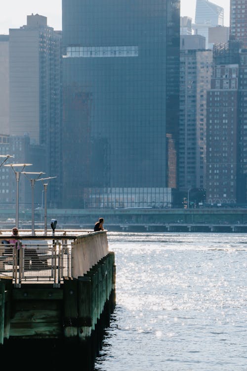 View of People on a Pier in a Modern City Downtown 