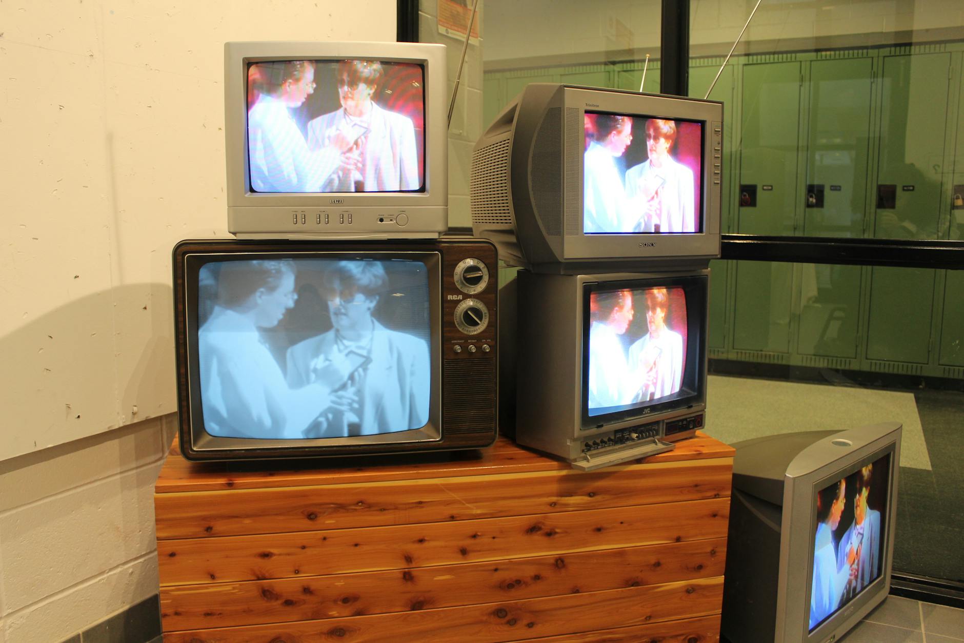 A collection of vintage CRT televisions showing retro media indoors, evoking nostalgia.