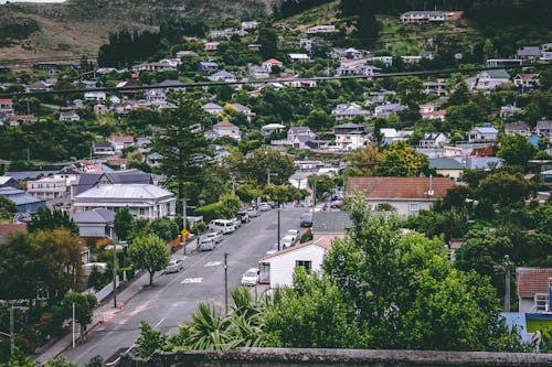 Birds Eye View Photography of Cars on Street Between Houses