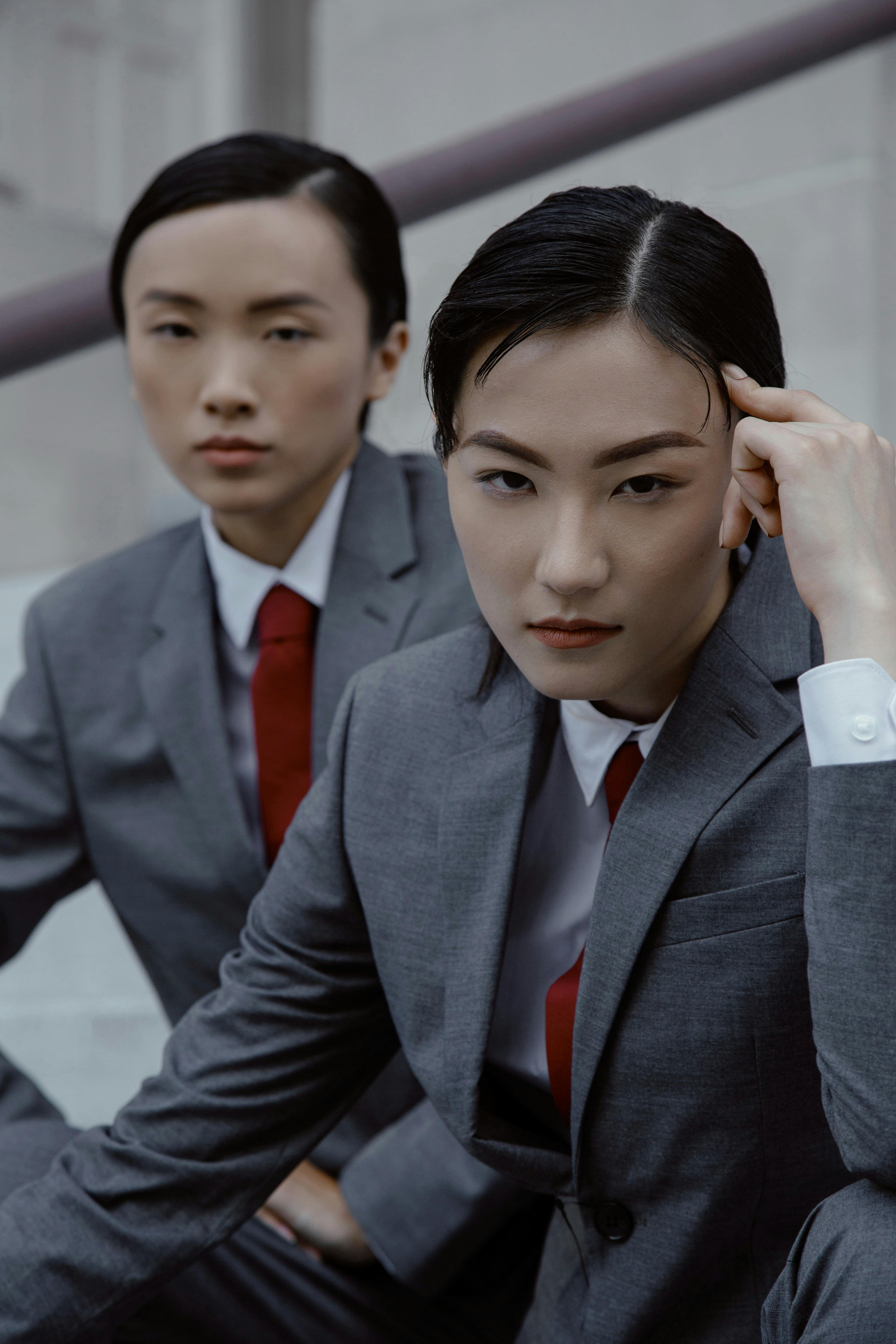 women in gray suits with red ties