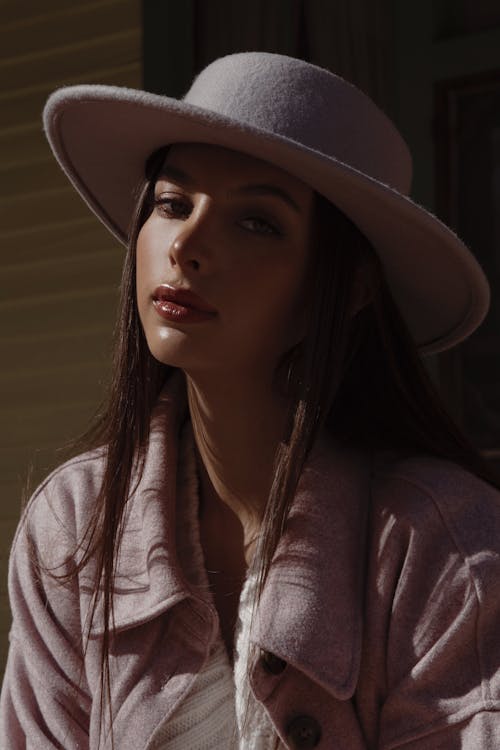 Woman Wearing Pink Jacket and Hat Posing