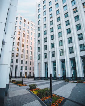 White skyscrapers with glass facades in a vibrant cityscape.