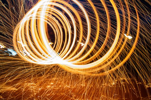 Captivating long exposure of light painting in Casablanca with vibrant swirling sparks.