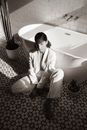 Man in White Suit Sitting on Bathtub