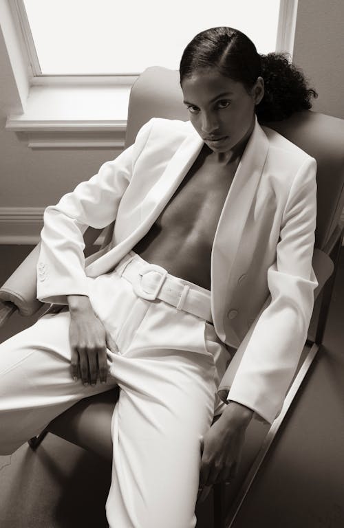 Man in White Suit Sitting on White Wooden Bench