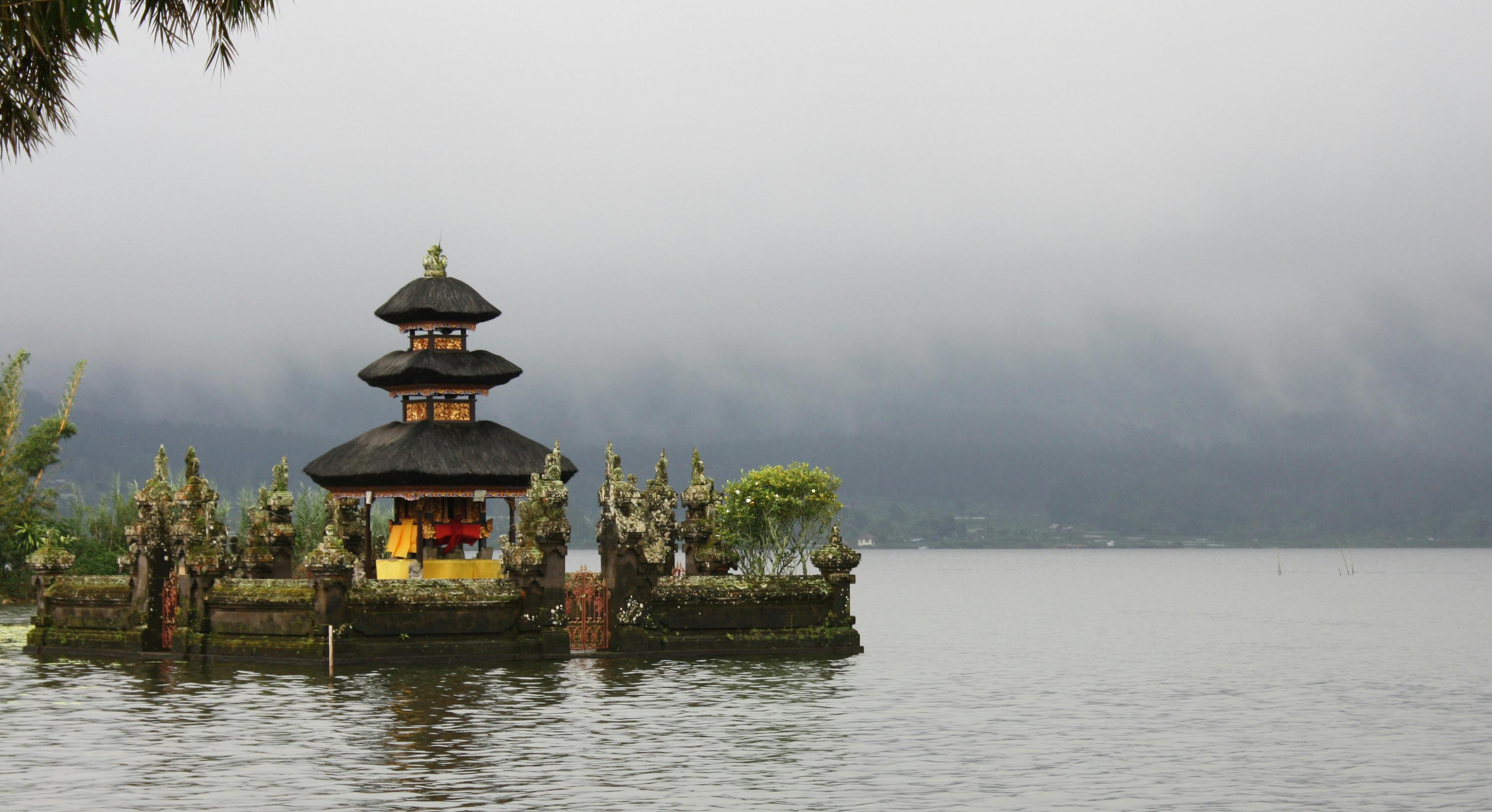 Brown and Green Temple on Island Surrounded by Water · Free Stock Photo