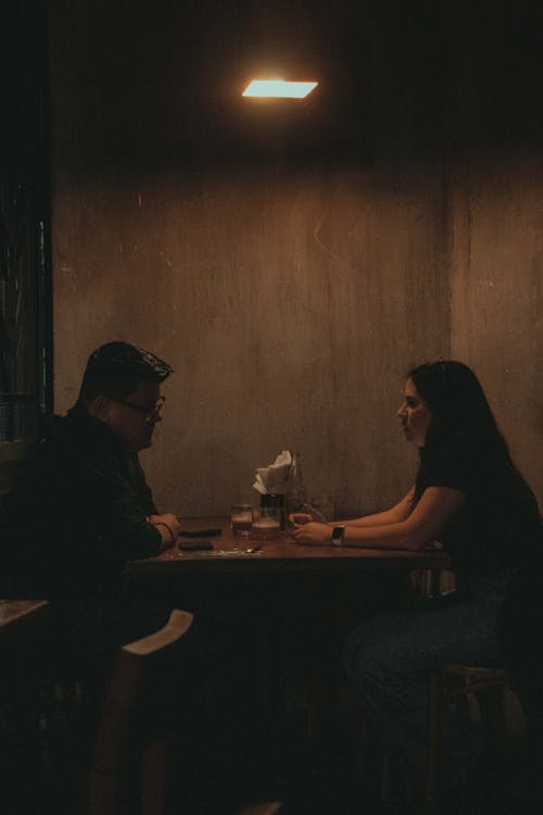 Man and Woman Sitting at the Table