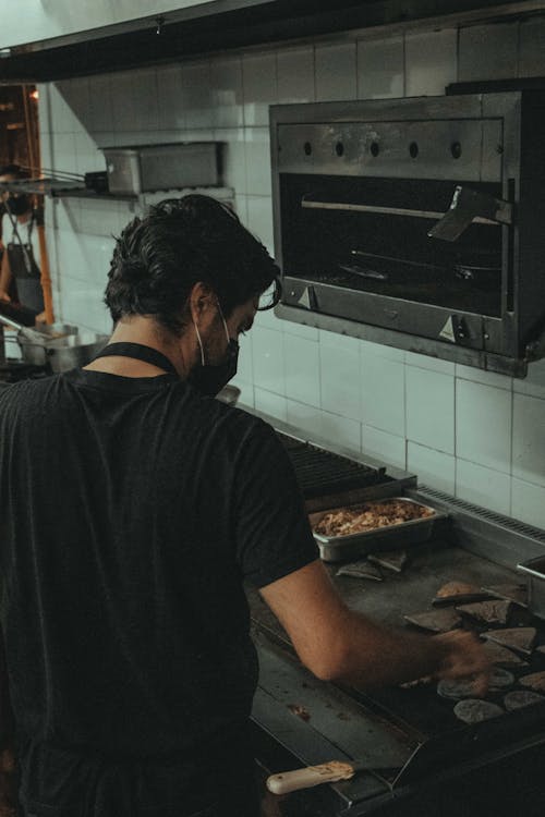 Man in Black Crew Neck T-shirt Cooking