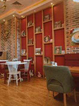 Warm and inviting café interior with vintage decor and modern seating arrangements.