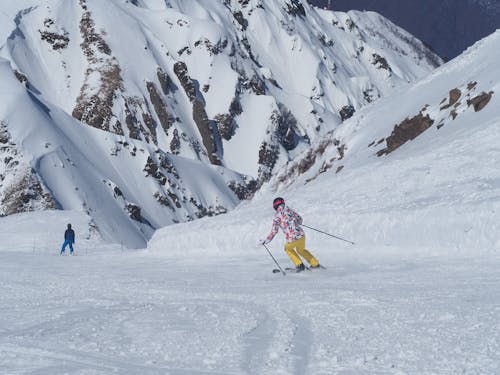 Free A Person Skiing on the Snow Near the Mountain Stock Photo