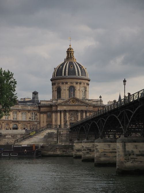 Free Stunning view of the Institute of France with a bridge and cloudy sky in Paris. Stock Photo