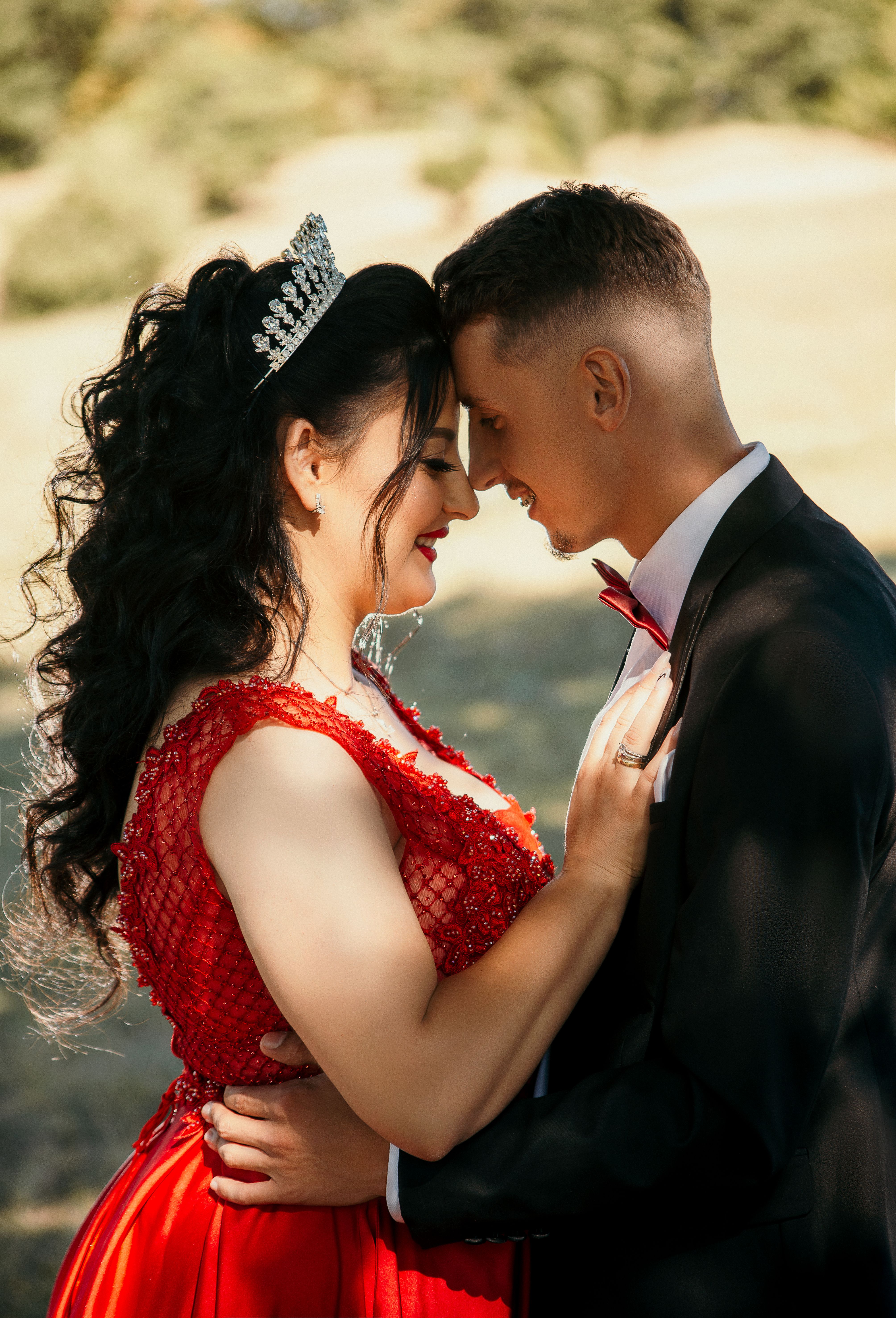 A Woman in Red Gown and a Man in Black Formal Suit Standing Facing Each  Other  Free Stock Photo